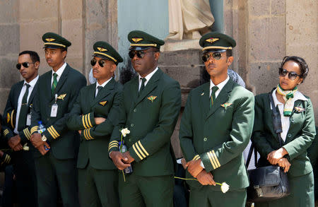 Ethiopian Airlines crew members mourn as pallbearers carry the coffins of their colleagues of the Ethiopian Airline Flight ET 302 plane crash, during the burial ceremony at the Holy Trinity Cathedral Orthodox church in Addis Ababa, Ethiopia, March 17, 2019. REUTERS/Maheder Haileselassie