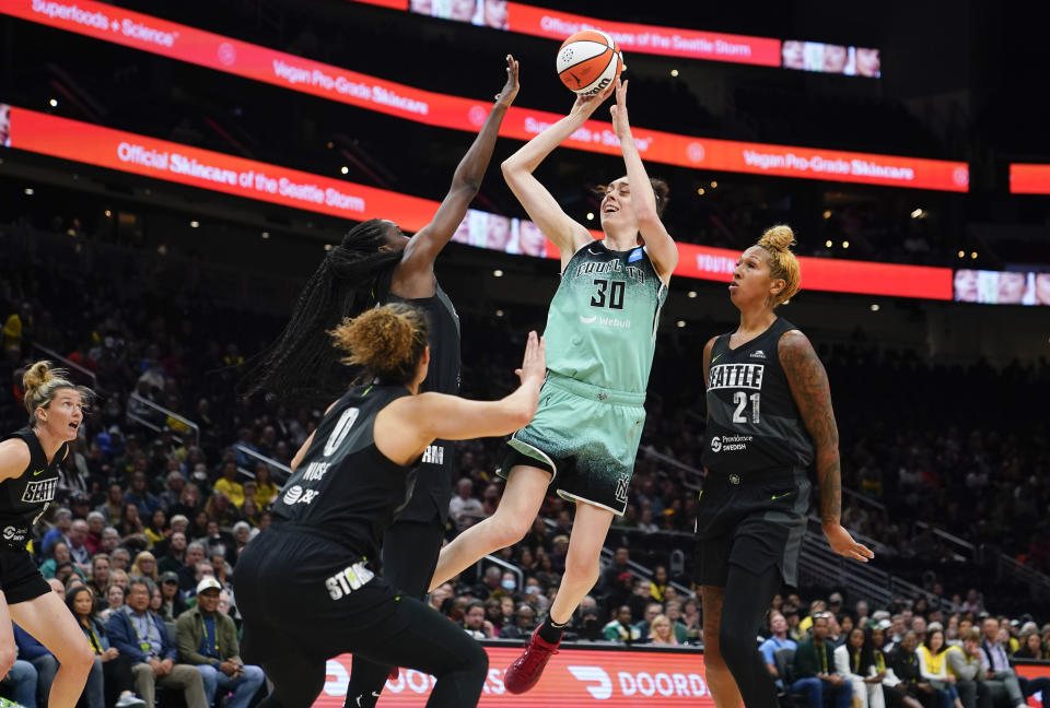 New York Liberty forward Breanna Stewart (30) shoots from between Seattle Storm guard Kia Nurse (0), center Ezi Magbegor and center Mercedes Russell (21) during the first half of a WNBA basketball game Tuesday, May 30, 2023, in Seattle. (AP Photo/Lindsey Wasson)