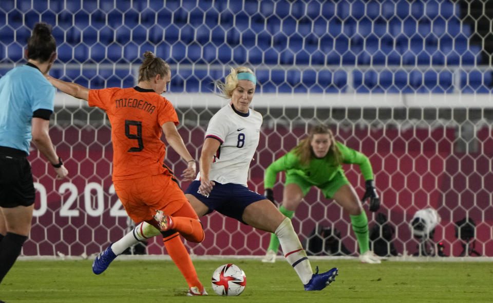 Netherlands' Vivianne Miedema, left, strikes the ball to score her side's 2nd goal during a women's quarterfinal soccer match against United States at the 2020 Summer Olympics, Friday, July 30, 2021, in Yokohama, Japan. (AP Photo/Kiichiro Sato)