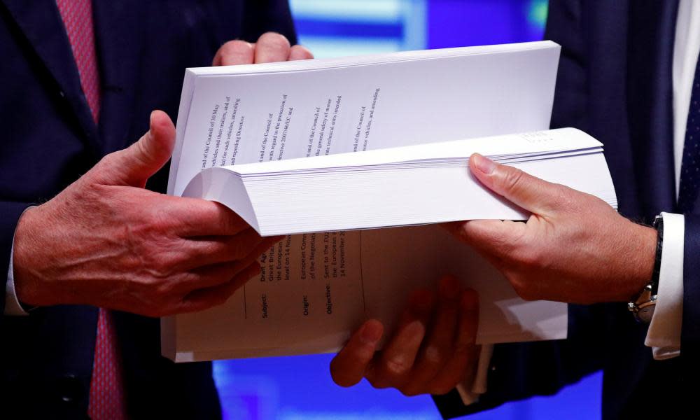 Hands hold the Brexit draft text