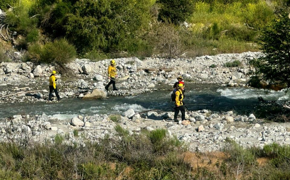 San Bernardino County Fire Department officials search for the two children (AP)