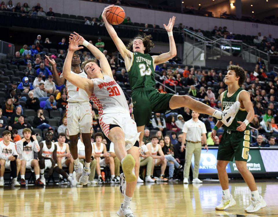 Washington's Noah Robertson and Jefferson's Kaden Year collide in attempt to catch a rebound in the first round of the high school boys state basketball tournament on Thursday, March 17, 2022, at the the Denny Sanford Premier Center in Sioux Falls.