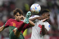 Portugal's Joao Felix, left, and Switzerland's Edimilson Fernandes battle for the ball during the World Cup round of 16 soccer match between Portugal and Switzerland, at the Lusail Stadium in Lusail, Qatar, Tuesday, Dec. 6, 2022. (AP Photo/Manu Fernandez)