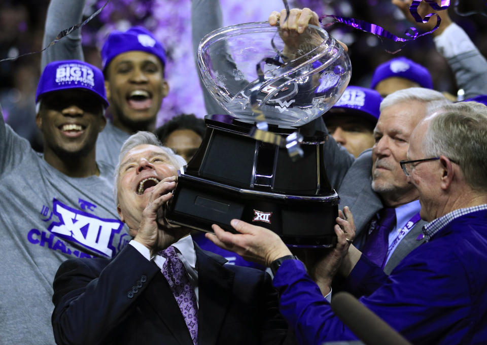 Kansas State head coach Bruce Weber takes hold of the Big 12 trophy following an NCAA college basketball game against Oklahoma in Manhattan, Kan., Saturday, March 9, 2019. Kansas State defeated Oklahoma 68-53. Kansas State shares the regular season title with Texas Tech. (AP Photo/Orlin Wagner)