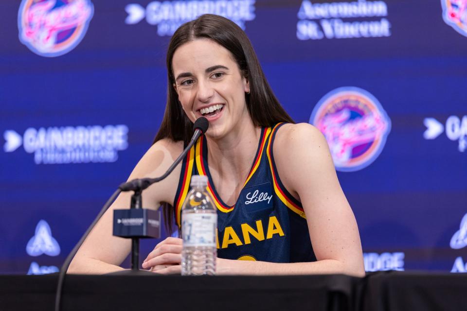 <p>Michael Hickey/Getty</p> Caitlin Clark #22 of the Indiana Fever talks to reporters at Gainbridge Fieldhouse on May 1, 2024 in Indianapolis, Indiana