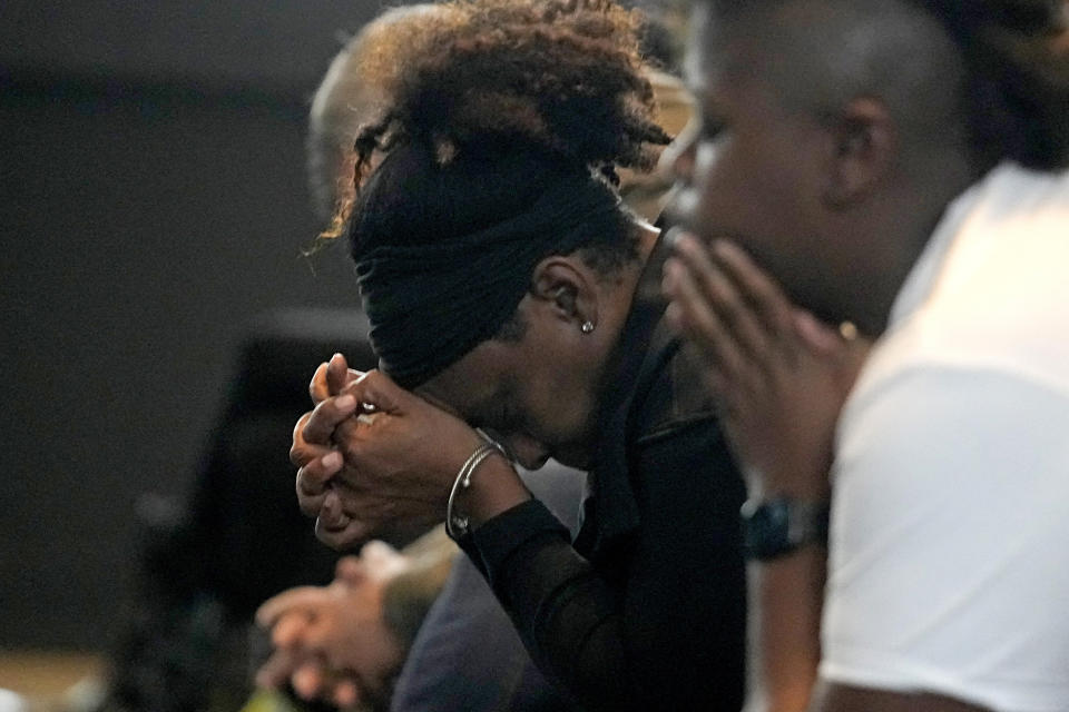 A woman prays during a prayer service for Buffalo Bills' Damar Hamlin at Crossroads Uptown Church, Tuesday, Jan. 3, 2023, in Cincinnati. The family of Damar Hamlin expressed gratitude for the outpouring of support shown toward the Buffalo Bills safety who suffered cardiac arrest after making a tackle while asking everyone to keep the hospitalized player in their prayers on Tuesday. (AP Photo/Darron Cummings)