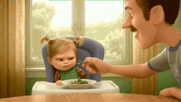 An animated scene of a toddler, Riley from Inside Out, refusing to eat broccoli and tossing it while her father tries to feed her