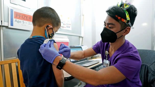 PHOTO: Andre Mattus, right, a nurse at the University of Washington Medical Center, gives the first shot of the Pfizer COVID-19 vaccine to Amar Gunderson, 6 1/2, Nov. 9, 2021, in Seattle. (Ted S. Warren/AP, FILE)