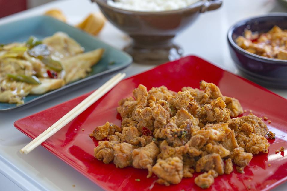 Chongqing Spicy Chicken, along with hand-torn cabbage and Braised bean curd with minced pork from Xin Wei Kitchen