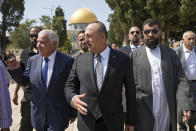 Turkish Foreign Minister Mevlut Cavusoglu, center, and Sheikh Azzam Al-Khatib, left, Director of Jerusalem Waqf Department, with other dignitaries visit the Al Aqsa Mosque compound in Jerusalem's Old City, Wednesday, May 25, 2022. (AP Photo/Mahmoud Illean)