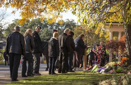 People line up for public visitation for Cpl. Nathan Cirillo outside a funeral home in Hamilton, October 27, 2014. REUTERS/Mark Blinch