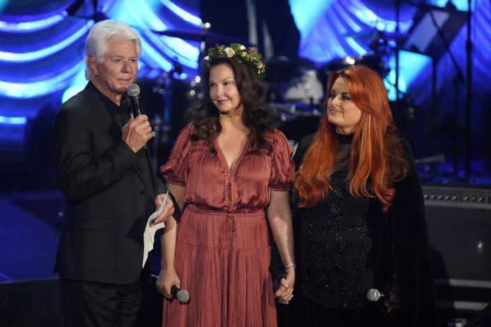 NASHVILLE, TENNESSEE - MAY 15: (L-R) Larry Strickland, Ashley Judd, and Wynonna Judd speak onstage for Naomi Judd: &#39;A River Of Time&#39; Celebration at Ryman Auditorium on May 15, 2022 in Nashville, Tennessee. (Photo by Mickey Bernal/Getty Images)