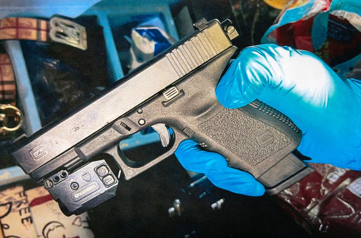 A Worcester Police evidence photo shows a Glock semi-automatic pistol that has been modified with a so-called Glock switch that converts the gun to fully automatic. The device is seen on the upper right of the gun. An illegal extended magazine, holding more than 10 rounds of ammunition, is also seen in the gun.