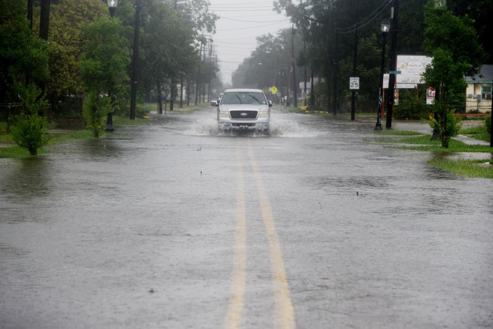 A truck drives through a street in New Iberia, La., after Hurricane Barry made landfall. The National Weather Service says Barry brought a 7-foot storm surge to parts of south Louisiana.