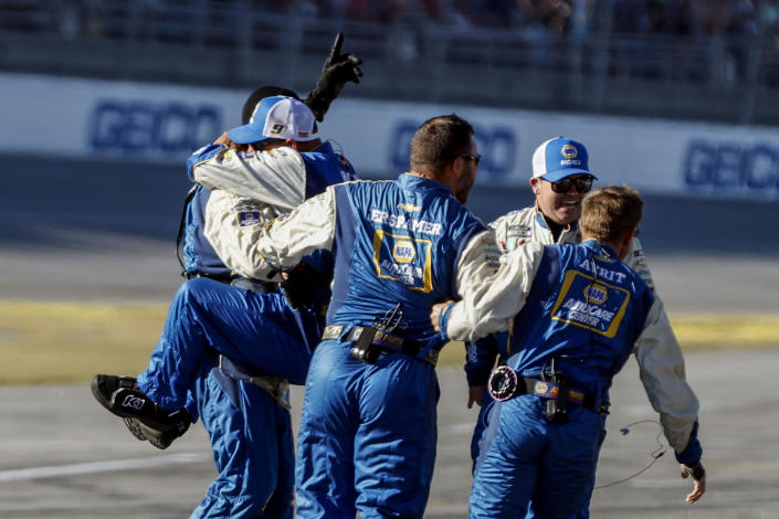 Chase Elliott's crew celebrates after winning a NASCAR Cup Series auto race Sunday, Oct. 2, 2022, in Talladega, Ala. (AP Photo/Butch Dill)