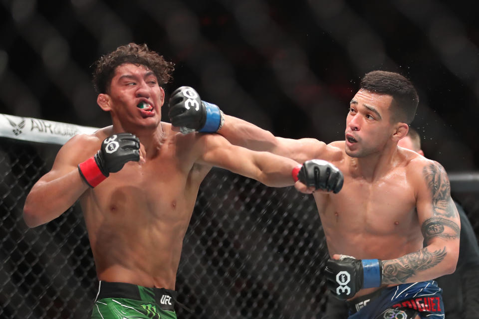 MIAMI, FLORIDA - APRIL 8: (R-L) Christian Rodriguez punches Raul Rosas Jr. in their bantamweight fight during the UFC 287 event on April 8, 2023, at the Kaseya Center in Miami, FL. (Photo by Alejandro Salazar/PxImages/Icon Sportswire via Getty Images)