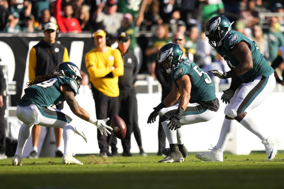 Philadelphia Eagles cornerback Avonte Maddox, left, picks up a fumble by Pittsburgh Steelers quarterback Kenny Pickett during the second half of an NFL football game between the Pittsburgh Steelers and Philadelphia Eagles, Sunday, Oct. 30, 2022, in Philadelphia. (AP Photo/Matt Slocum)