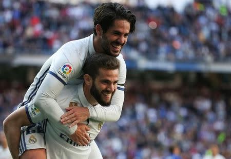 Football Soccer - Real Madrid v Alaves - Spanish La Liga Santander - Santiago Bernabeu Stadium, Madrid, Spain - 02/04/17 - Real Madrid's Nacho Fernandez (bottom) is congratulated by teammate Isco after scoring. REUTERS/Sergio Perez