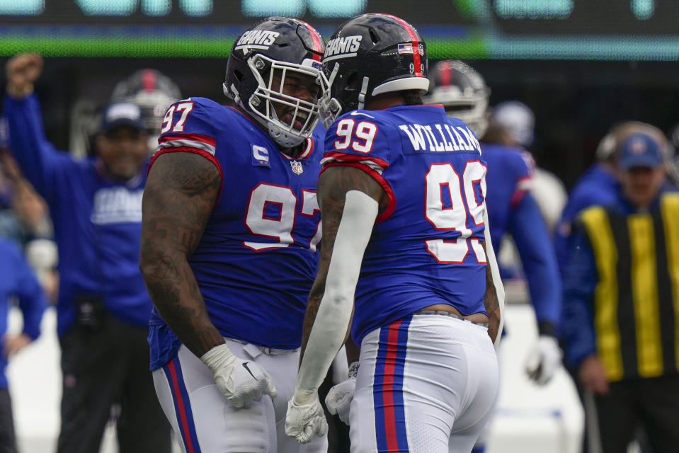 New York Giants defensive tackle Dexter Lawrence II (97) and defensive end Leonard Williams (99) react during the third quarter of an NFL football game against the Washington Commanders, Sunday, Oct. 22, 2023, in East Rutherford, N.J. (AP Photo/Seth Wenig)