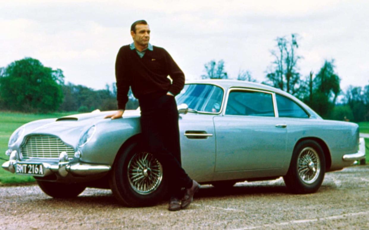 Sean Connery, who played James Bond, standing with the Aston Martin DB5 used in Goldfinger - Rex Features