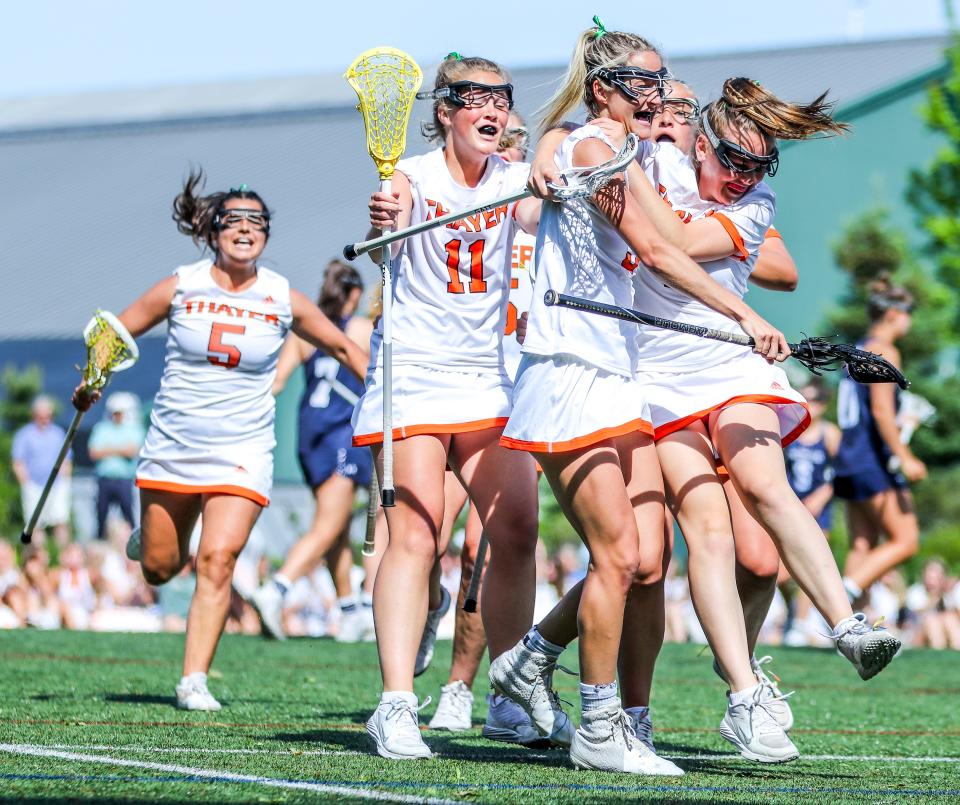 Thayer Academy's Caroline Lally leaps into Caroline Kendall's arms in celebration during the ISL championship game against Nobles at Milton Academy on Monday, May 23, 2022.