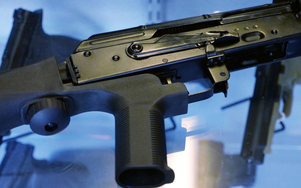 A bump stock attached to a semi-automatic rifle - AP