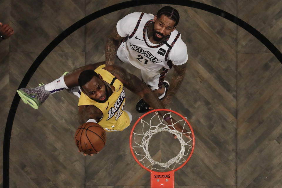 Los Angeles Lakers' LeBron James (23) drives past Brooklyn Nets' Wilson Chandler (21) during the first half of an NBA basketball game Thursday, Jan. 23, 2020, in New York. (AP Photo/Frank Franklin II)