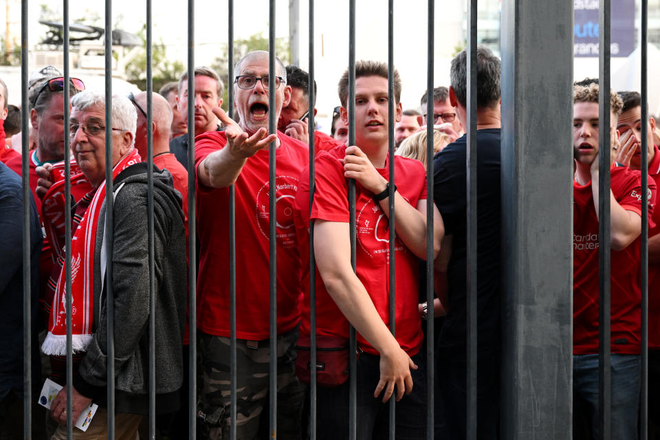 Liverpool fans react as they queue outside Stade de France prior to the UEFA Champions League final in Paris. 