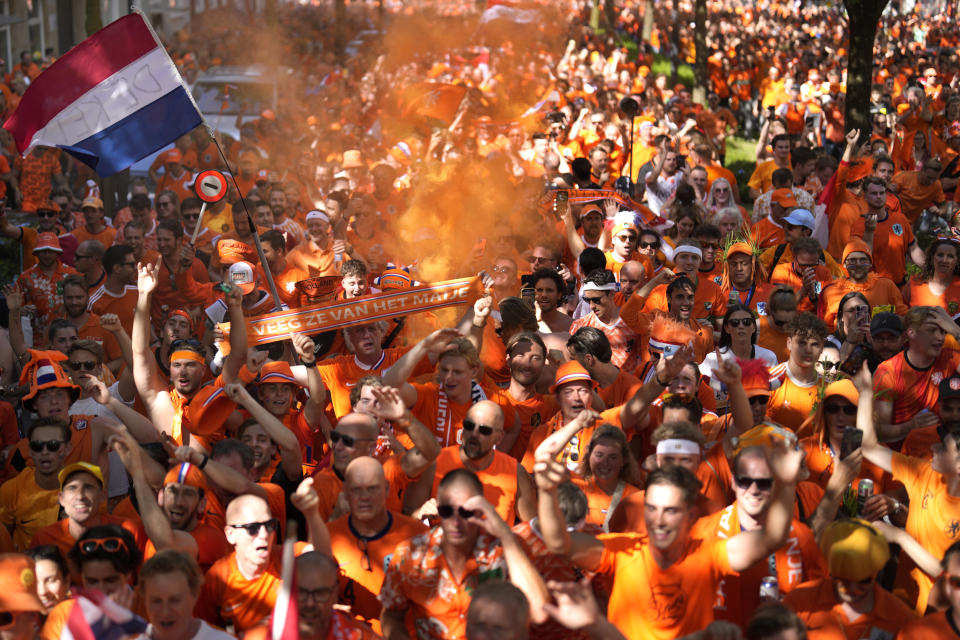 Fans of the team of the Netherlands walk towards the stadium ahead of a semifinal match between the Netherlands and England at the Euro 2024 soccer tournament in Dortmund, Germany, Wednesday, July 10, 2024. (AP Photo/Markus Schreiber)