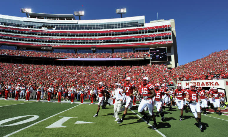 Nebraska Cornhuskers Head Coach Bo Pelini (center) leads his team onto the field before their game against the Udaho Vandals at Memorial Stadium.