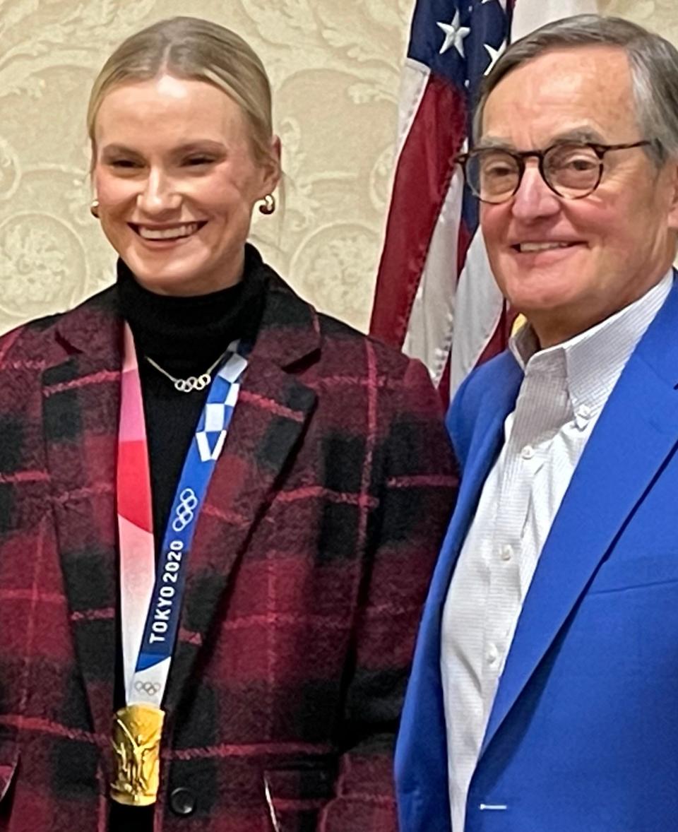 Olympic gold medalist Katie Moon and track and field journalist Dave Hunter pose for a photograph after discussing Moon's pole-vaulting career Thursday during an Akron Roundtable session at Quaker Station.