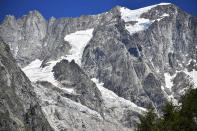 The Planpincieux glacier, located in the Alps on the Grande Jorasses peak of the Mont Blanc massif, is seen from Val Ferret, a popular hiking area on the south side of the Mont Blanc, near Courmayeur, northern Italy, Friday, Aug. 7, 2020. Some 70 people were evacuated Thursday in the valley below the glacier and roads closed after the threat of collapse the the fast-moving melting glacier is posing to the picturesque valley near the Alpine town of Courmayeur. (Claudio Furlan/LaPresse via AP)