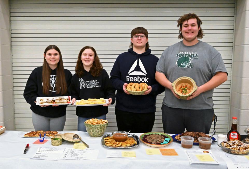 Smithville High School Foreign Language Club members Nylah Kaufman, left, Ava Windhurst, Jacob John and Eric Lehman show off their delicious dishes.