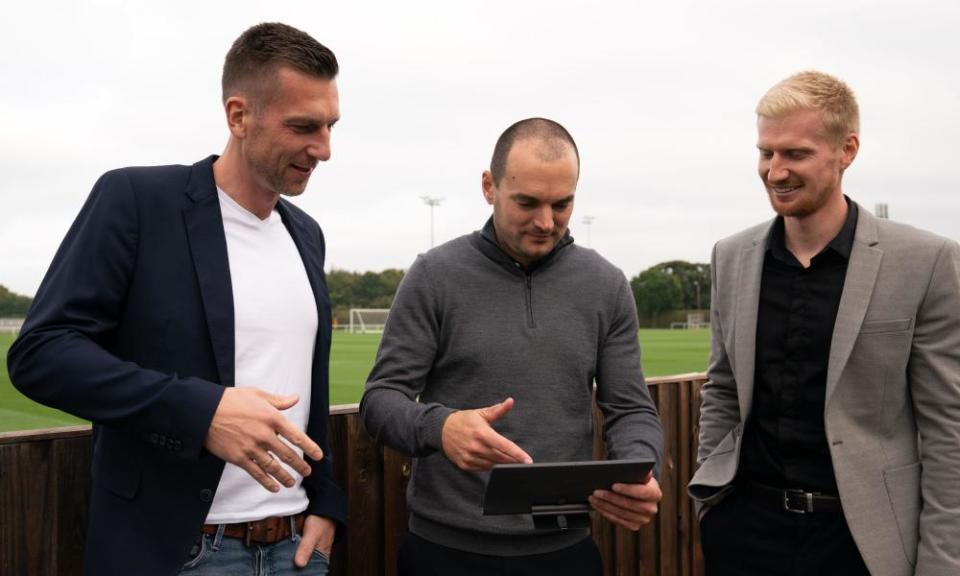 Stuart Webber (centre) consults the Premier League table.