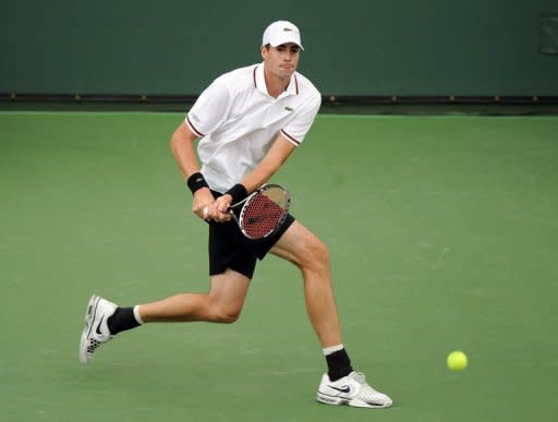 American John Isner returns a backhand to Novak Djokovic of Serbia at the Indian Wells Tennis Garden in Indian Wells, California. Isner won 7-6 (9/7), 3-6, 7-6 (7/5)