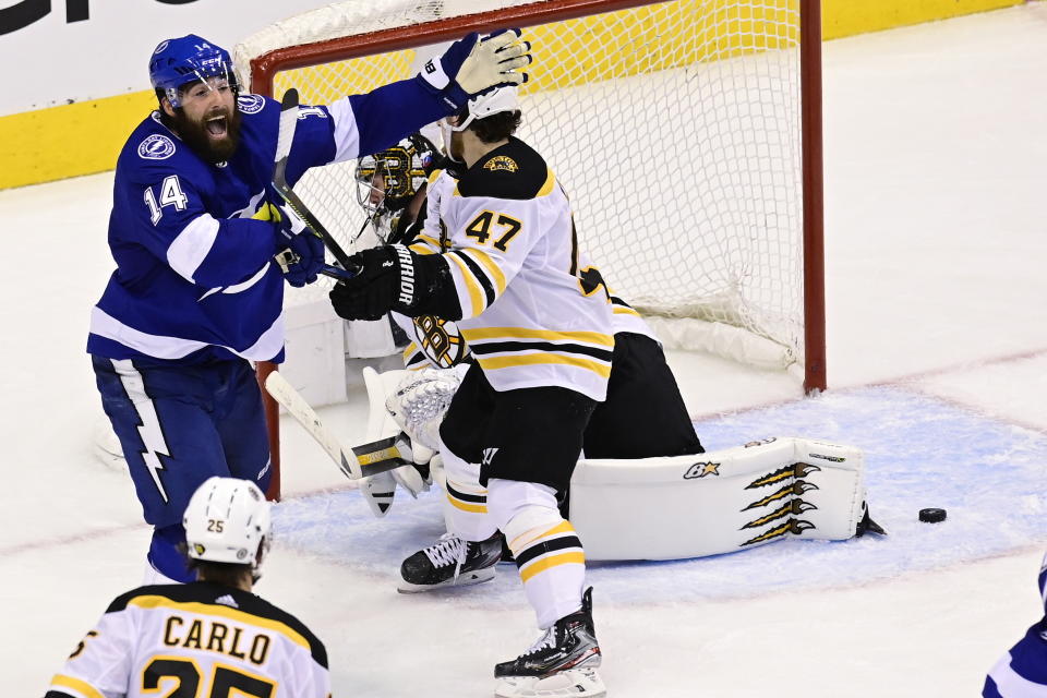 Tampa Bay Lightning left wing Patrick Maroon (14) celebrates the winning goal by teammate Victor Hedman (not shown) past Boston Bruins goaltender Jaroslav Halak (41) as Bruins defenseman Torey Krug (47) looks on during the second overtime period of NHL Stanley Cup Eastern Conference playoff hockey game action in Toronto, Monday, Aug. 31, 2020. (Frank Gunn/The Canadian Press via AP)