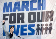 FILE- In this March 24, 2018 file photo, David Hogg, a survivor of the mass shooting at Marjory Stoneman Douglas High School in Parkland, Fla., raises his fist after speaking during the "March for Our Lives" rally in support of gun control in Washington. With every mass shooting, the survivors of Parkland, Florida's high school massacre are transported back to their own nightmare. Even though most are hundreds of miles away, having started new lives in college nearly four years later, the painful memories are always close.(AP Photo/Andrew Harnik, File)