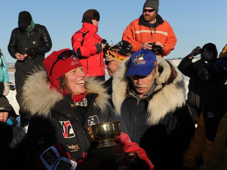 Aliy Zirkle accepts the Wells Fargo Gold Coast Award for the first musher to reach the Bering Sea in Unalakleet during the 2014 Iditarod Trail Sled Dog Race on Saturday, March 8, 2014. (AP Photo/The Anchorage Daily News, Bob Hallinen)