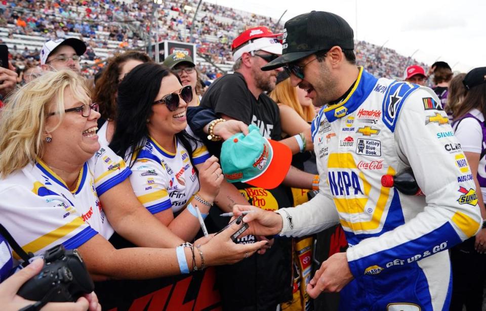 Apr 16, 2023; Martinsville, Virginia, USA; NASCAR Cup Series driver Chase Elliott (9) signs autographs before the NOCO 400 at Martinsville Speedway. Mandatory Credit: John David Mercer-USA TODAY Sports