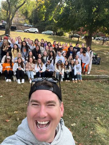 <p>Courtesy of Rachael Sullivan</p> Tom Sullivan takes a selfie with college students.