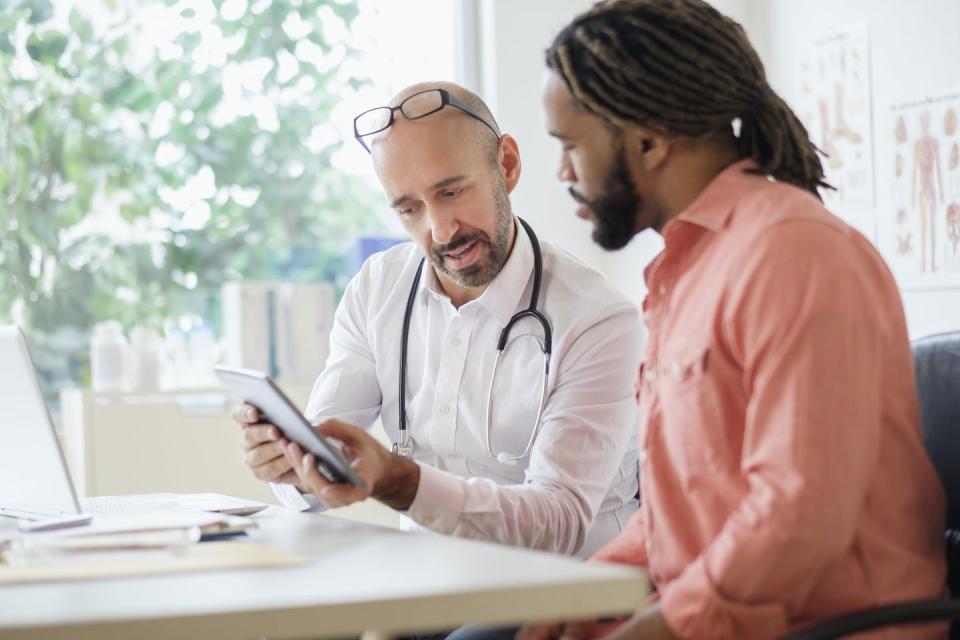 <span class="caption">Health care professionals need to be aware of their implicit bias.</span> <span class="attribution"><a class="link " href="https://www.gettyimages.com/detail/photo/doctor-giving-consultation-to-patient-using-digital-royalty-free-image/602981371?adppopup=true" rel="nofollow noopener" target="_blank" data-ylk="slk:Getty Images / Tetra Images;elm:context_link;itc:0;sec:content-canvas">Getty Images / Tetra Images</a></span>