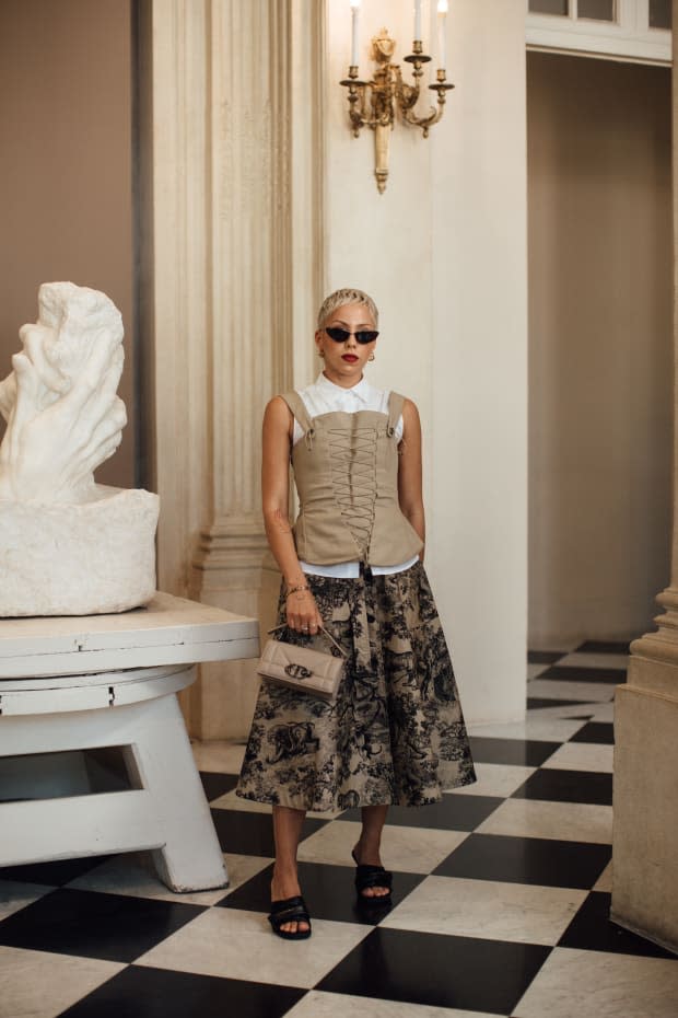 A corset-inspired top layered over a button-up and midi skirt during Haute Couture Fashion Week.<p>Photo: Imaxtree</p>