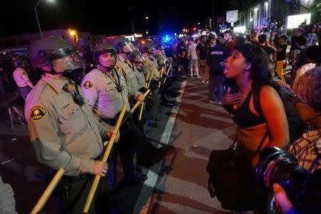 Protesters gather along Broadway Avenue to protest the fatal shooting of an unarmed black man on Tuesday by officers in El Cajon, California, U.S. September 28, 2016. REUTERS/Sandy Huffaker