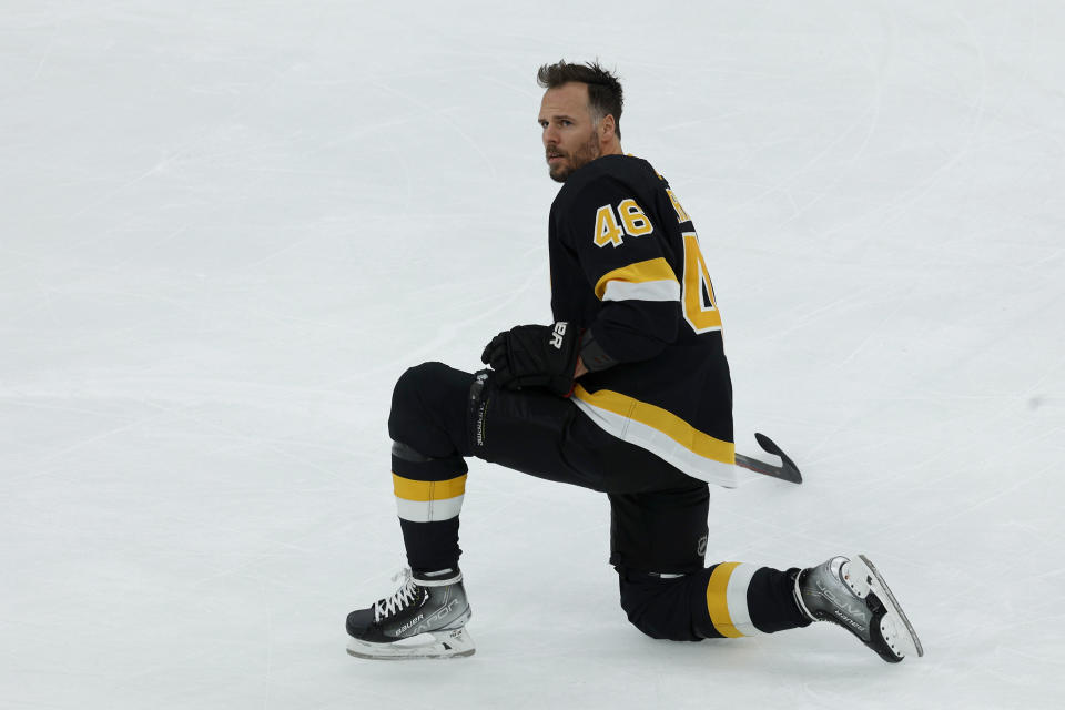 Boston Bruins center David Krejci (46), playing in his 1000th game for the Bruins, stretches on the ice during warmups before the start of an NHL hockey game against the Philadelphia Flyers, Monday, Jan. 16, 2023, in Boston. (AP Photo/Mary Schwalm)