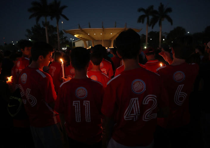 <p>Students hold candles during a vigil for victims of the mass shooting at Marjory Stoneman Douglas High School yesterday, at Pine Trail Park, on Feb. 15, 2018 in Parkland, Fla. (Photo: Mark Wilson/Getty Images) </p>