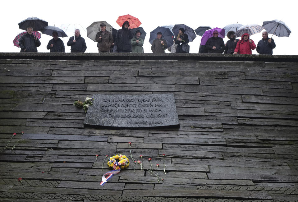 People gather at the memorial center to pay their respects for tens of thousands of people killed in death camps run by Croatia's pro-Nazi puppet state in WWII, in Jasenovac, Croatia, Friday, April 12, 2019. Croatia's Jewish, Serb, anti-fascist and Roma groups have commemorated the victims of a World War II death camp, snubbing the official ceremonies for the fourth year in a row over what they say is government inaction to curb neo-Nazi sentiments in the European Union country. (AP Photo/Nikola Solic)