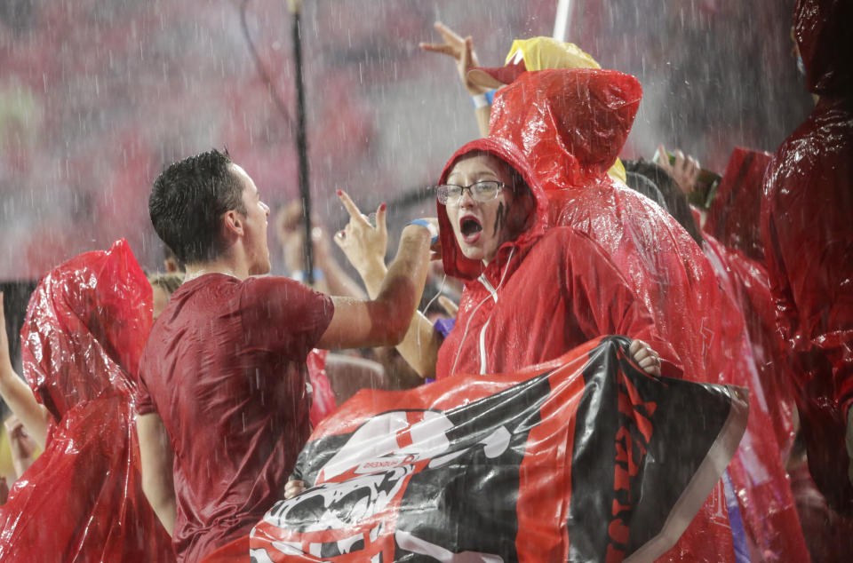 Fans at Memorial Stadium dance to music during a lightning and rain delay in the first half of an NCAA college football game between Nebraska and Akron in Lincoln, Neb., Saturday, Sept. 1, 2018. (AP Photo/Nati Harnik)