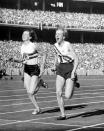 FILE - In this Dec. 1, 1956, file photo, Australia's Betty Cuthbert, right, wins the 4 x 100-meter relay final, in a new world Record time of 44.5 seconds, at Melbourne, Australia. (AP Photo/File)