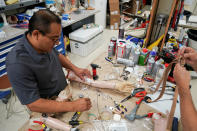 <p>A worker prepares a prosthetic arm during a fitting at the Shriners Hospital in Philadelphia, Pa., on May 30, 2017. (Photo: Carlo Allegri/Reuters) </p>