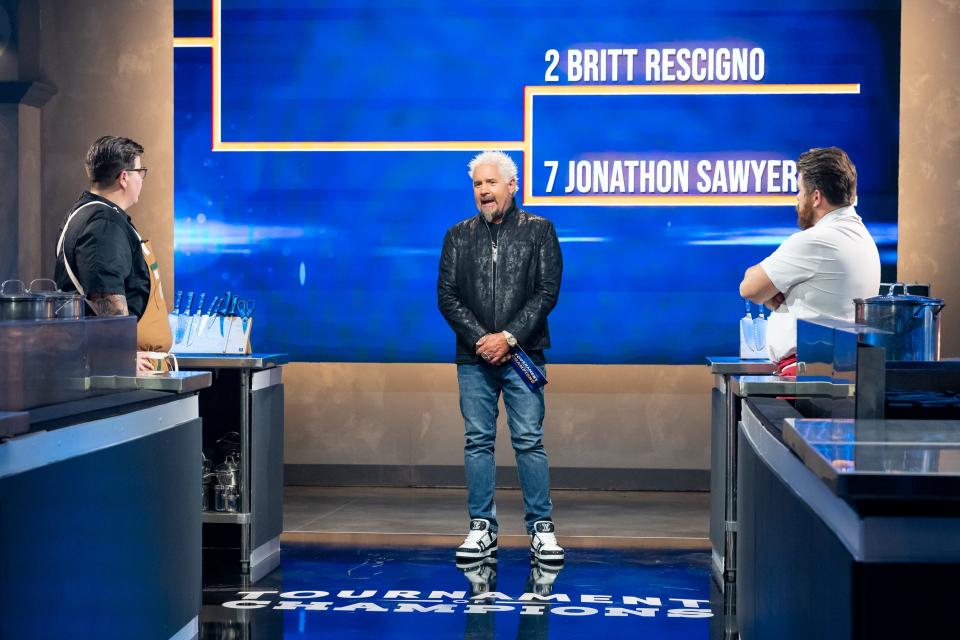 Host Guy Fieri with contestants Britt Rescigno and Jonathon Sawyer during the season five premiere of Food Network's "Tournament of Champions."